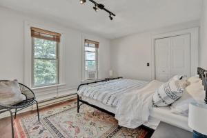 a white bedroom with a bed and a window at City Oasis Awaits Cozy DT Home With Hot Tub Vikings in Minneapolis +23 photos