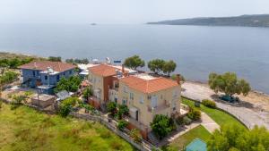 an aerial view of a house by the water at Palaiologou Panorama Apartments in Mantamádos