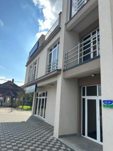 a large white building with its doors open at Janjić Apartmani in Zvornik
