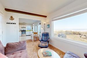 a living room with a view of the ocean at Breakers Cottage in Rockaway Beach