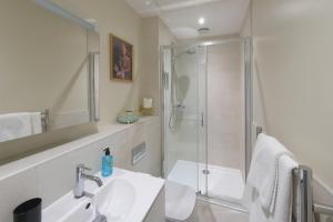 a bathroom with a shower and a sink at Dream Stays Bath - John Street Apartments in Bath +56 photos