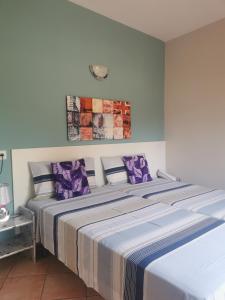 a bedroom with two beds with purple pillows at Apartamento tosca mar con balcon 421 in Moraira +7 photos