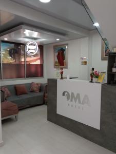 a waiting room with a couch and a counter at OMA HOTEL LA GUAJIRA in Camarones