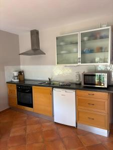 a kitchen with a stove and a white dishwasher at Apartamento tosca mar con balcon 421 in Moraira