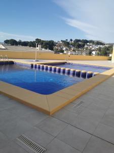 a large swimming pool with blue water on a building at Apartamento tosca mar con balcon 421 in Moraira