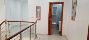 a hallway with a stair case and a stair railing at Villa midoun in Taguermess