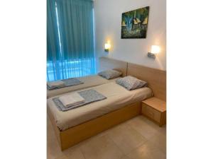 a bedroom with a bed with two pillows on it at Sunny Villa in Byala +7 photos