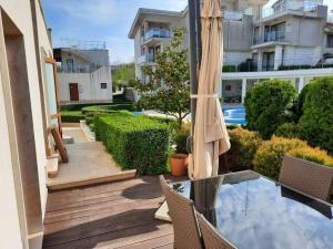a patio with a table and chairs and a pool at Sunny Villa in Byala
