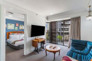 a hotel room with a bed and a tv at Boutique Apt in the Heart of Auckland Zodiak Stays in Auckland