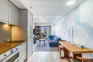 a kitchen with a table and a dining room at Boutique Apt in the Heart of Auckland Zodiak Stays in Auckland