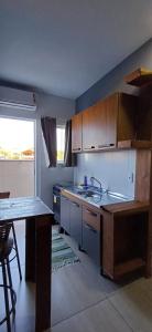a kitchen with a sink and a counter top at Loft 02 in Bombinhas