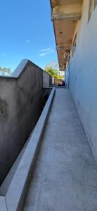 an empty hallway of a building with a concrete wall at Loft 02 in Bombinhas +1 photo