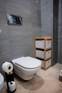 a bathroom with a white toilet and a sink at Premium Flat at Ajuda/Belém with Balcony, Parking! in Lisbon