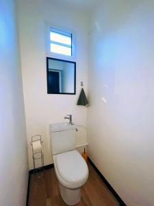 a bathroom with a white toilet and a window at Sweety blue, vue mer in Les Trois-Îlets +14 photos