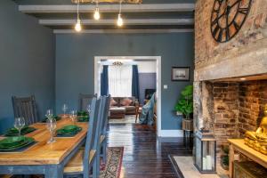 a dining room with a table and a fireplace at Characterful Terrace Retreat in County Durham - Sleeps 6 in Stanley