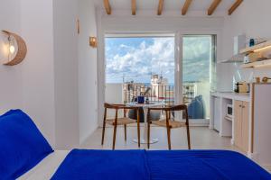 a bedroom with a bed and a table and chairs at Mediterranean Loft in Alicante