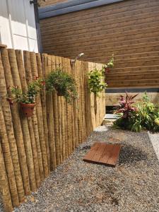 a wooden fence with potted plants on it at Pousada Vilas Boas - Suíte Casal 1 in Cavalcante