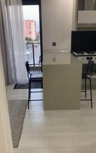 a kitchen with a white counter and a table and chairs at Lux Suite Room in YeÅŸilkÃ¶y +12 photos