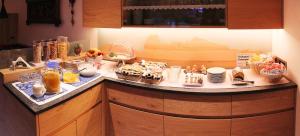 a counter with many different types of food on it at Garni Martlhof in Selva di Val Gardena