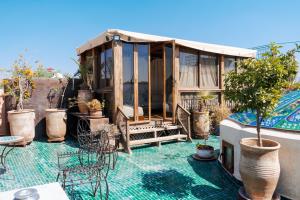 a tiny house on a rooftop with a pool at Boutique Hotel Riad Almoulouk in Marrakesh
