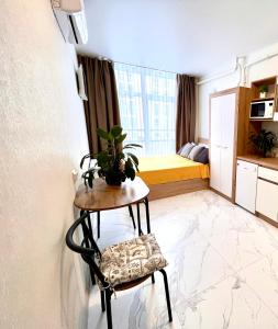 a room with a table with a plant on it at OSapart hotel in a complex Semycvit 8 in Lviv