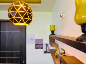 a yellow light hanging over a counter in a room at 7 Seasons Palm Suite with Sky Orbit, Balcony, Swimming pool, WIFI, Playground in Rajkot