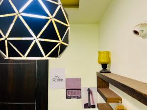 a chandelier hanging over a staircase in a room at 7 Seasons Palm Suite with Sky Orbit, Balcony, Swimming pool, WIFI, Playground in Rajkot