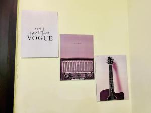 a refrigerator with a picture of a guitar and a note at 7 Seasons Palm Suite with Sky Orbit, Balcony, Swimming pool, WIFI, Playground in Rajkot