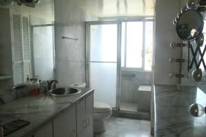 a bathroom with a sink and a toilet and a shower at Condominio Galeón in Acapulco +22 photos
