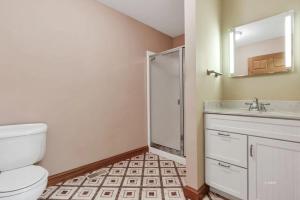 a bathroom with a shower and a toilet and a sink at Buck Run - a secluded cabin in Rockbridge, OH in Rockbridge +42 photos
