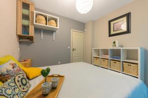 a bedroom with a bed and a couch and shelves at Sunny Flat-4 People-Delta Mall-Private Parking Space in Wladislawowo