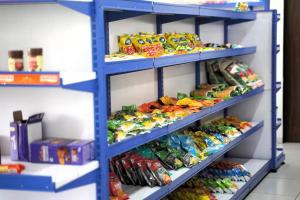 a store shelf filled with different types of food at 7 Seasons Palm Suite with Sky Orbit, Balcony, Swimming pool, WIFI, Playground in Rajkot