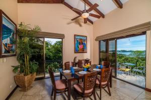 a dining room with a table with chairs and a ceiling fan at Infinity Pool, Pacific Views & Concierge in Potrero