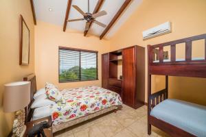 a bedroom with a bunk bed and a ceiling fan at Infinity Pool, Pacific Views & Concierge in Potrero