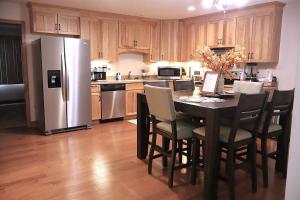 a kitchen with a table with chairs and a refrigerator at Buck Run - a secluded cabin in Rockbridge, OH in Rockbridge