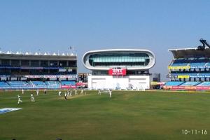 a group of people playing cricket on a field in a stadium at 7 Seasons Palm Suite with Sky Orbit, Balcony, Swimming pool, WIFI, Playground in Rajkot