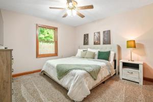 a bedroom with a bed and a ceiling fan at Buck Run - a secluded cabin in Rockbridge, OH in Rockbridge