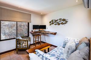 a living room with a couch and a table at Private Villa, Infinity Pool, 2 Quiet Beaches in Potrero +16 photos