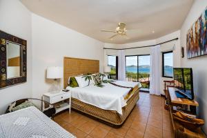 a bedroom with a bed and a view of the ocean at Private Villa, Infinity Pool, 2 Quiet Beaches in Potrero