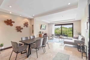 a dining room with a table and chairs at Spacious Luxury 4 Bed Condo in Ocotal in Ocotal