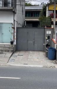 a building with a gate and a motorcycle parked next to a street at Loft 205 em frente à Vila Germânica- Villa Haus in Blumenau