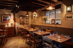 a dining room with wooden tables and chairs at The Angel at Burford in Burford
