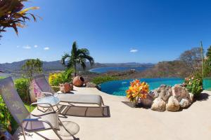 a patio with two chairs and a swimming pool at Breathtaking Views & Stunning Infinity Pool in Potrero