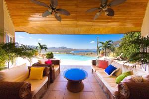 a patio with couches and a view of a pool at Breathtaking Views & Stunning Infinity Pool in Potrero