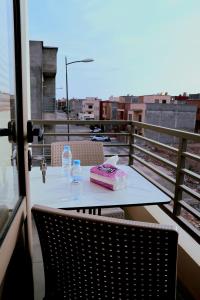 a table with a cake and water bottles on a balcony at The Elite suites in Marrakesh
