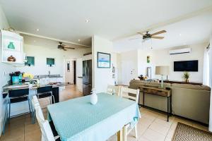 a kitchen and living room with a table and a dining room at Beachfront Hideaway with Pool & Ocean Views in Playa Flamingo +10 photos