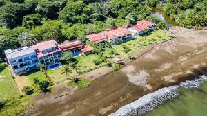 an aerial view of a house on a island near the water at Beachfront Hideaway with Pool & Ocean Views in Playa Flamingo