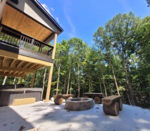 a patio with a fire pit in front of a building at The Saige - Hot Tub, Fire Pit, and huge entertainment area in Logan