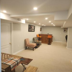 a living room with two chairs and a podium at Rare 3 Bedroom Luxury Close to Lake in Oakville