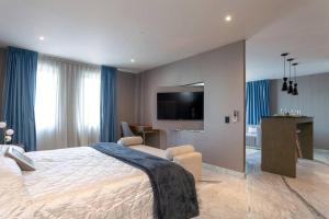 a bedroom with a large bed and a flat screen tv at Close to Beach Nice Suite in Cabo's Downtown - 5 in Cabo San Lucas